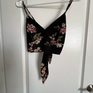 Black with floral printing v neck crop top. Ties in the back